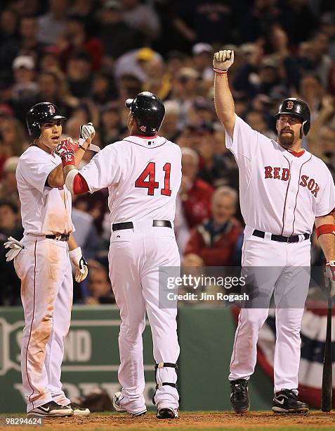 Victor Martinez celebrates his home run with Jacoby Ellsbury and Kevin Youkilis, all of the Boston Red Sox against the New york Yankees attempts to...