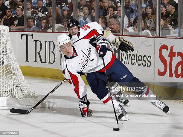 Alexander Semin of the Washington Capitals moves the puck in front of Matt Cooke of the Pittsburgh Penguins on April 6, 2010 at Mellon Arena in...
