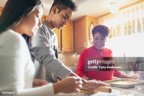 mother son and daughter baking together in home kitchen - asian mom cooking stock pictures, royalty-free photos & images