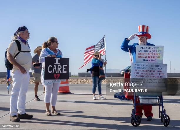 Leon Blevins, dressed as Uncle Sam, salutes other attendees during the "End Family Detention," event held at the Tornillo Port of Entry in Tornillo,...