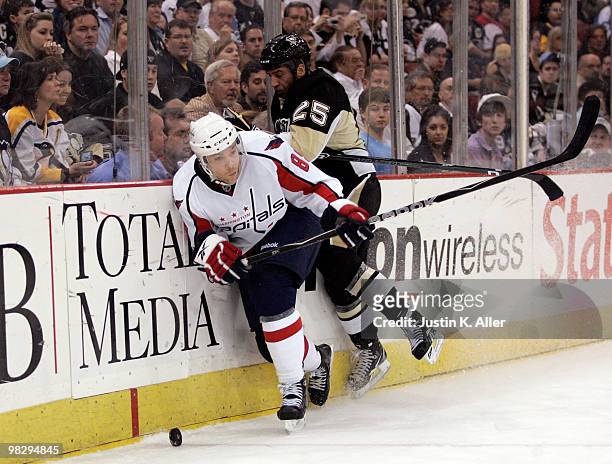 Tyler Sloan of the Washington Capitals battles for the puck along the boards with Maxime Talbot of the Pittsburgh Penguins in the first period at...