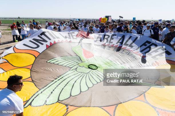 Activists hold a decorated parachute during the "End Family Detention," event held at the Tornillo Port of Entry in Tornillo, Texas on June 24, 2018....
