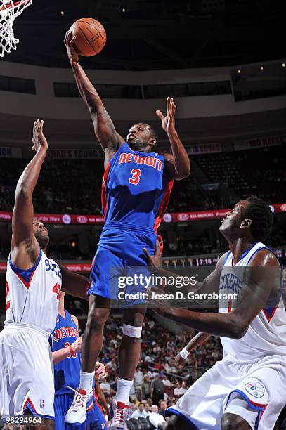 Rodney Stuckey of the Detroit Pistons shoots against Elton Brand and Samuel Dalembert of the Philadelphia 76ers during the game on April 6, 2010 at...