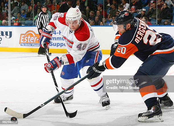 Andrei Kostitsyn of the Montreal Canadiens and Sean Bergenheim of the New York Islanders battle for the puck on April 6, 2010 at Nassau Coliseum in...