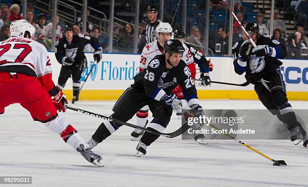 Martin St. Louis of the Tampa Bay Lightning controls the puck against the Carolina Hurricanes at the St. Pete Times Forum on April 6, 2010 in Tampa,...