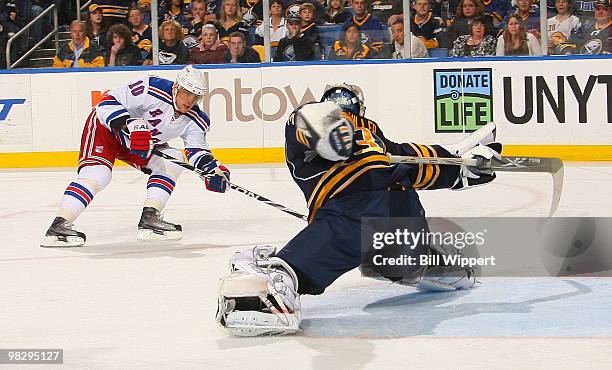 Ryan Miller of the Buffalo Sabres reaches out with his stick to make a save against Marian Gaborik of the New York Rangers on April 6, 2010 at HSBC...