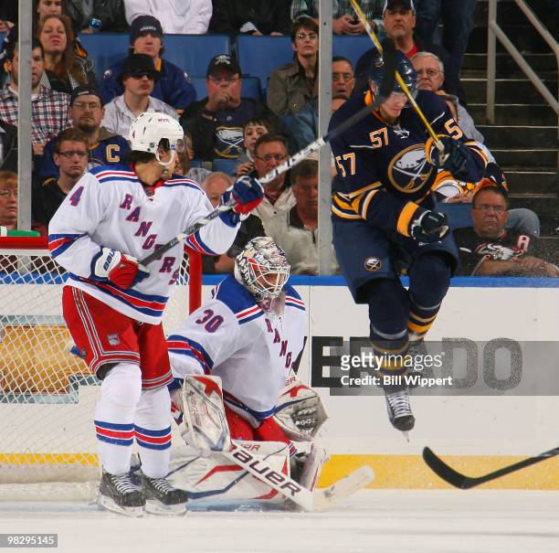 Tyler Myers of the Buffalo Sabres jumps to screen Henrik Lundqvist of the New York Rangers on a goal scored by Jochen Hecht of the Buffalo Sabres on...