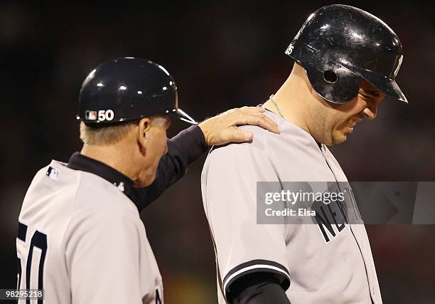 Nick Johnson of the New York Yankees is consoled by Mick Kelleher after Johnson was hit by a pitch from Jon Lester of the Boston Red Sox on April 6,...