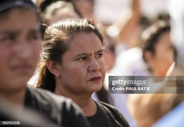 Woman listens during the "End Family Detention," event held at the Tornillo Port of Entry in Tornillo, Texas on June 24, 2018. - Texas is at the...