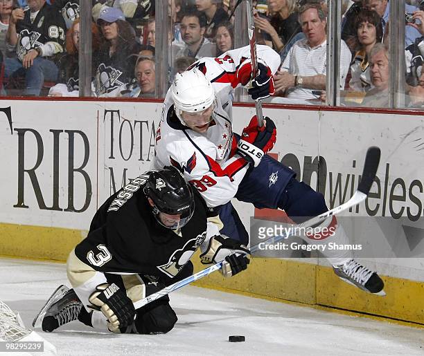 Alex Goligoski of the Pittsburgh Penguins trips up David Steckel of the Washington Capitals on April 6, 2010 at Mellon Arena in Pittsburgh,...