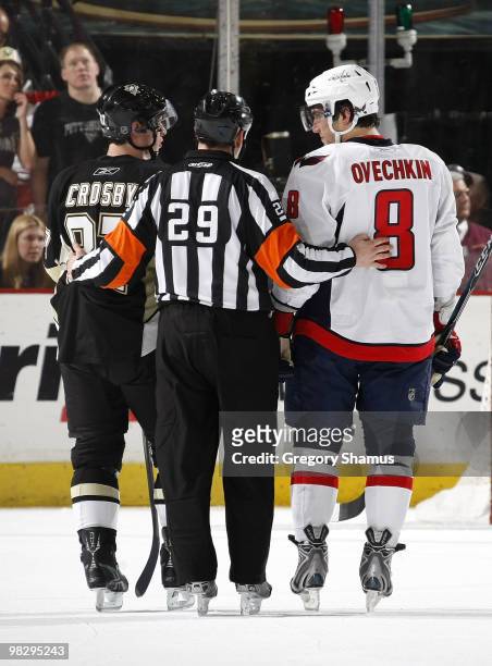 Sidney Crosby of the Pittsburgh Penguins and Alex Ovechkin of the Washington Capitals talk with referee Ian Walsh on April 6, 2010 at Mellon Arena in...
