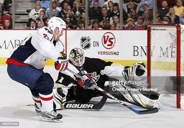 Brent Johnson of the Pittsburgh Penguins stops a shot by Jason Chimera of the Washington Capitals on April 6, 2010 at Mellon Arena in Pittsburgh,...