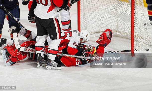 Chris Neil of the Ottawa Senators lays on top of goaltender Tomas Vokoun of the Florida Panthers after Jarkko Ruutu scored a goal on April 6, 2010 at...
