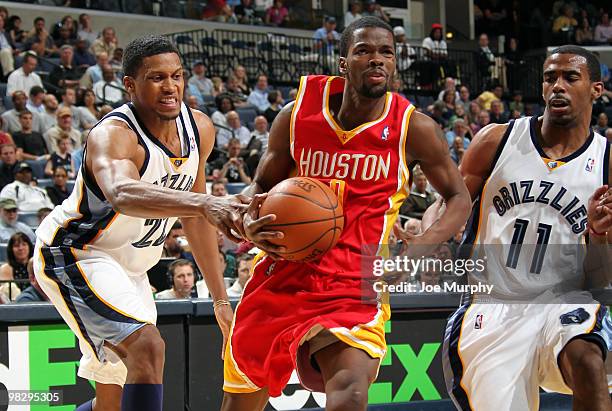 Rudy Gay and Mike Conley of the Memphis Grizzlies fight to strip the ball around Aaron Brooks of the Houston Rockets on April 06, 2010 at FedExForum...