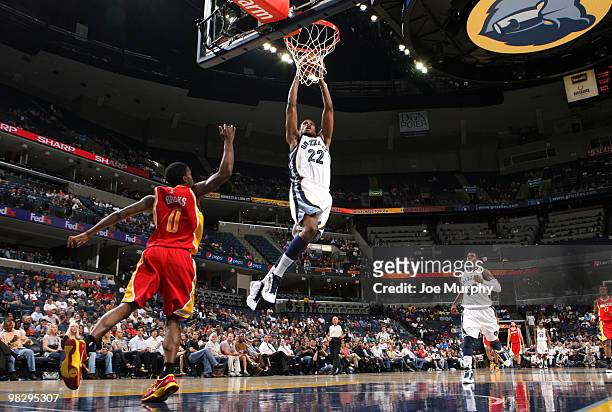 Rudy Gay of the Memphis Grizzlies dunks over Aaron Brooks of the Houston Rockets on April 06, 2010 at FedExForum in Memphis, Tennessee. NOTE TO USER:...