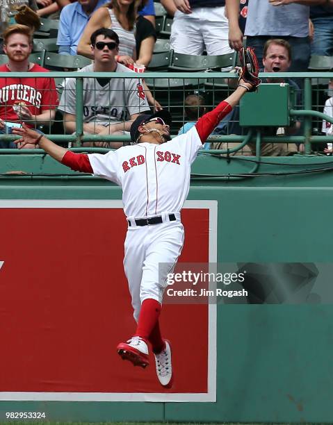 Mookie Betts of the Boston Red Sox makes a leaping catch on a ball hit by Mitch Haniger of the Seattle Mariners in the sixth inning at Fenway Park on...