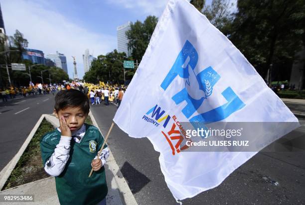 Boy attends the final rally of the presidential campaign of Mexican candidate Ricardo Anaya, standing for the "Mexico al Frente" coalition of the...