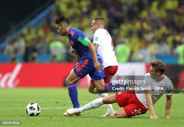 Lukasz Piszczek of Poland tackles Radamel Falcao of Colombia during the 2018 FIFA World Cup Russia group H match between Poland and Colombia at Kazan...