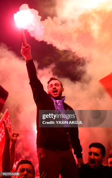 People shout slogans and let off flares outside the Justice and Development Party headquarters Istanbul on June 24 after counting of votes in...