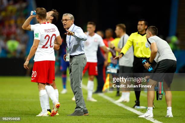 Adam Nawalka, Head coach of Poland speaks to Lukasz Piszczek of Poland during the 2018 FIFA World Cup Russia group H match between Poland and...