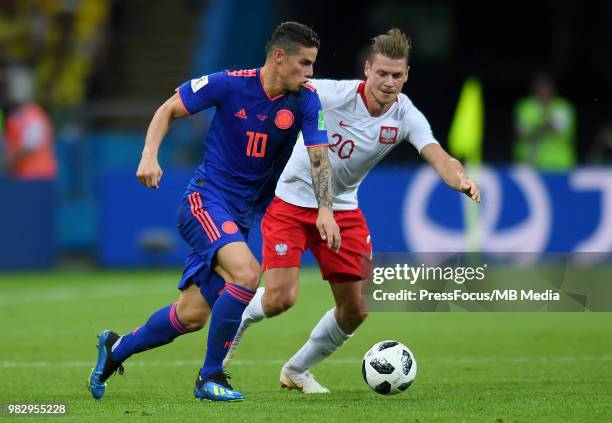 Lukasz Piszczek of Poland competes with James Rodriguez of Colombia during the 2018 FIFA World Cup Russia group H match between Poland and Colombia...