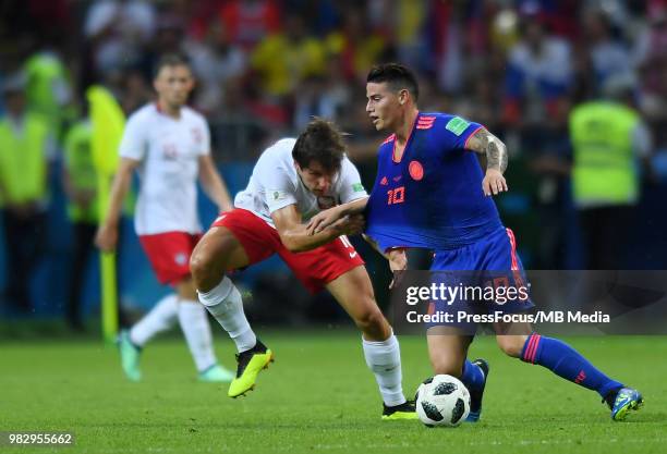 Grzegorz Krychowiak of Poland competes with James Rodriguez of Colombia during the 2018 FIFA World Cup Russia group H match between Poland and...