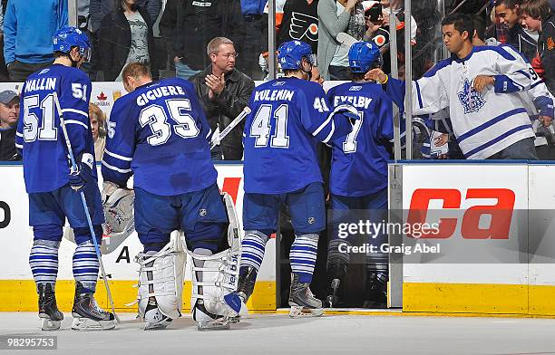 Rickard Wallin, Jean-Sebastien Giguere, Nikolai Kulemin and Garnet Exelby of the Toronto Maple Leafs leave the ice after their final home game of the...