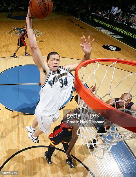 JaVale McGee of the Washington Wizards dunks against Anthony Tolliver of the Golden State Warriors at the Verizon Center on April 6, 2010 in...
