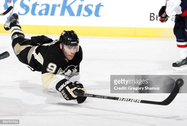 Pascal Dupuis of the Pittsburgh Penguins dives for the puck against the Washington Capitals on April 6, 2010 at Mellon Arena in Pittsburgh,...