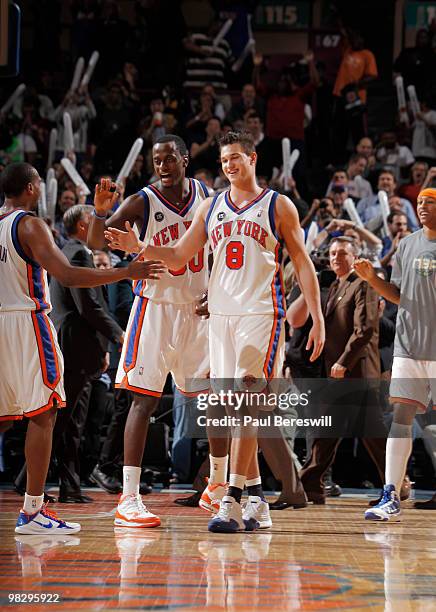 Danilo Gallinari, Earl Barron and Chris Duhon of the New York Knicks celebrate a basket by Gallinari near then end of a Knicks' win over the Boston...