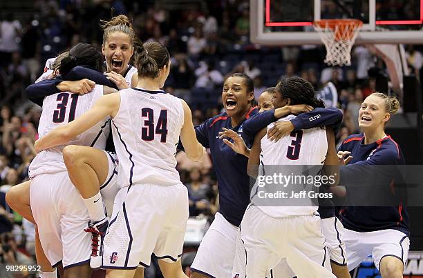 Tina Charles, Caroline Doty and Kelly Faris of the Connecticut Huskies celebrate a 53-47 win against the Stanford Cardinal during the NCAA Women's...