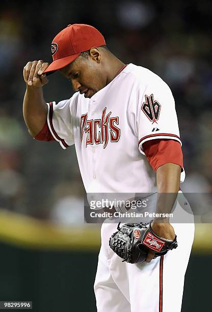Starting pitcher Edwin Jackson of the Arizona Diamondbacks reacts after giving up a solo home run to Will Venable of the San Diego Padres during the...