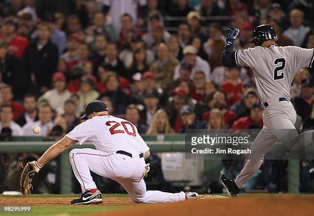 Derek Jeter of the New York Yankees reaches first to load the bases Kevin Youkilis of the Boston Red Sox is unable to field an errant throw in the...