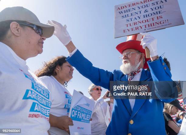 Leon Blevins, dressed as Uncle Sam, salutes other attendees during the "End Family Detention," event held at the Tornillo Port of Entry in Tornillo,...