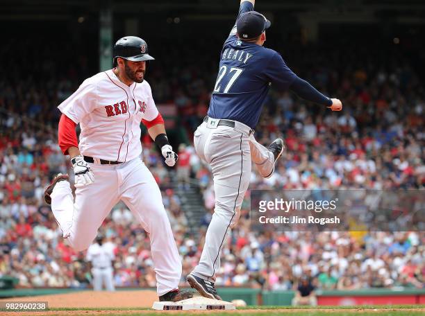Martinez of the Boston Red Sox beats the throw to Ryon Healy of the Seattle Mariners in the sixth inning at Fenway Park on June 24, 2018 in Boston,...