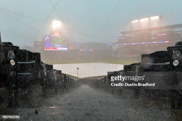 Rain and hail falls on the field during a weather delay before a scheduled game between the Colorado Rockies and the Miami Marlins at Coors Field on...