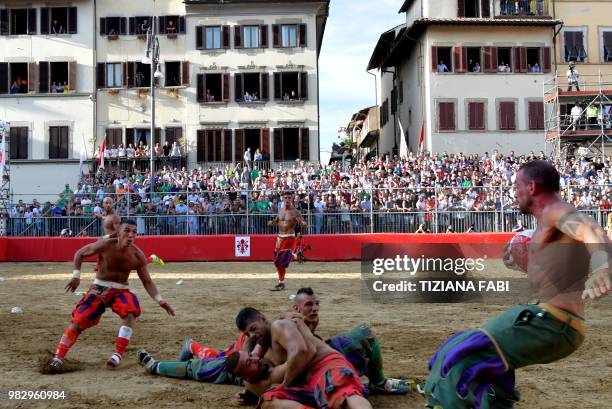 Players compete during the final match of the Calcio Storico Fiorentino on Piazza Santa Croce in Florence on June 24, 2018.