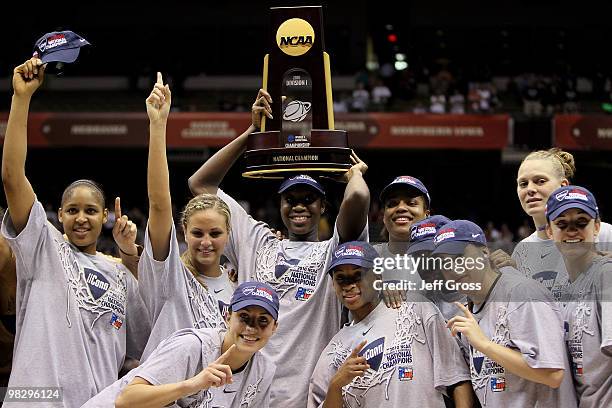 The Connecticut Huskies hold up the national championship trophy as they celebrate after a 53-47 win against the Stanford Cardinal during the NCAA...