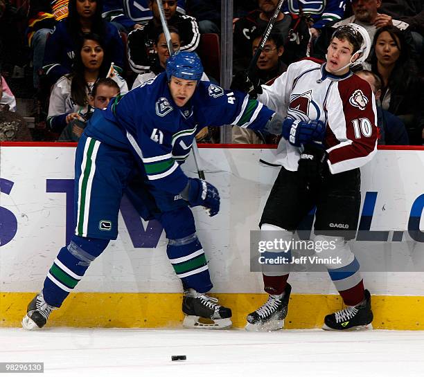 Andrew Alberts of the Vancouver Canucks keeps Kyle Cumiskey of the Colorado Avalanche in check during their game at General Motors Place on April 6,...
