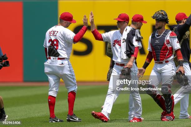 Cleveland Indians pitcher Adam Plutko gets a high-five from Cleveland Indians pitcher Oliver Perez as he walks in from the bullpen with Cleveland...