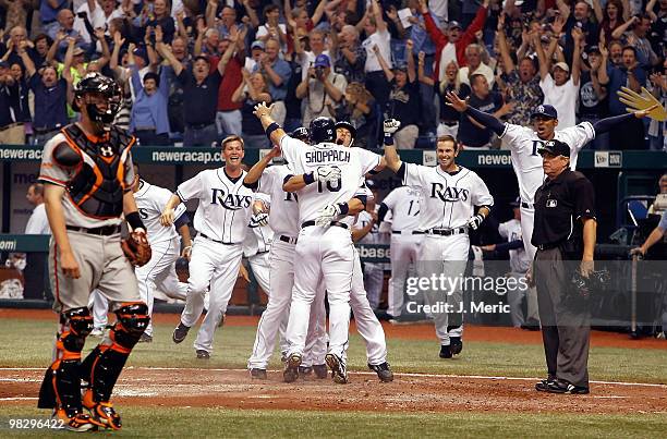 Pinch hitter Kelly Shoppach of the Tampa Bay Rays is mobbed by his teammates after he scored the winning run against the Baltimore Orioles during the...