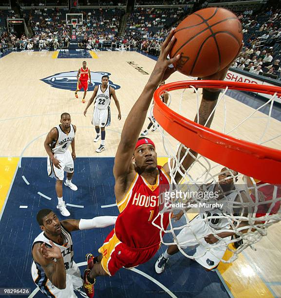 Trevor Ariza of the Houston Rockets dunks past O.J. Mayo of the Memphis Grizzlies on April 06, 2010 at FedExForum in Memphis, Tennessee. NOTE TO...