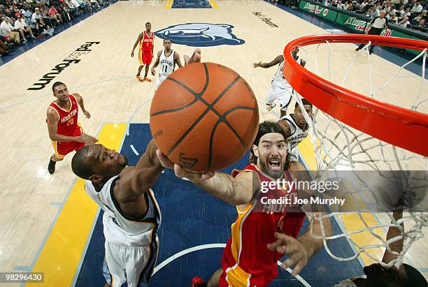 Luis Scola of the Houston Rockets and Sam Young of the Memphis Grizzlies fight for a rebound on April 06, 2010 at FedExForum in Memphis, Tennessee....