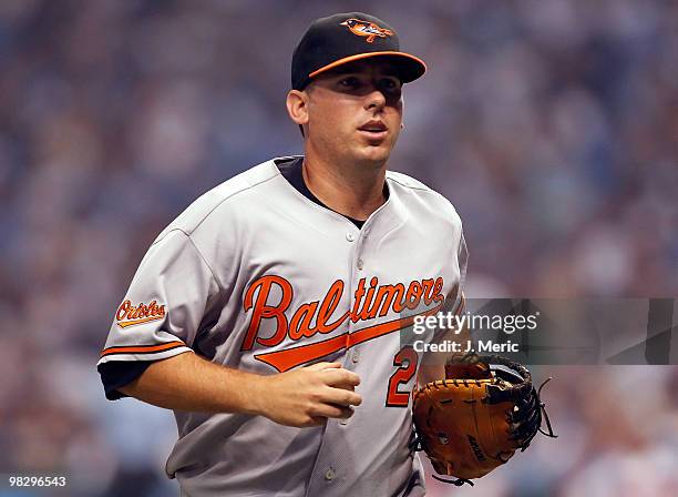 First baseman Garrett Atkins of the Baltimore Orioles jogs to the dugout against the Tampa Bay Rays during the home opener game at Tropicana Field on...