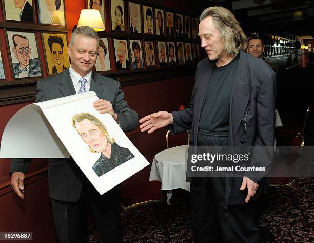 Max Klimavicius, Manager of the historic Sardis Restaurant presents actor Christopher Walken with his caricature during an unveiling ceremony to...