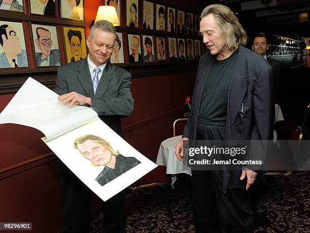 Max Klimavicius, Manager of the historic Sardis Restaurant presents actor Christopher Walken with his caricature during an unveiling ceremony to...