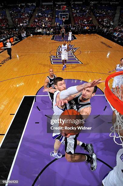 Manu Ginobili of the San Antonio Spurs gets to the basket against Andres Nocioni of the Sacramento Kings on April 6, 2010 at ARCO Arena in...