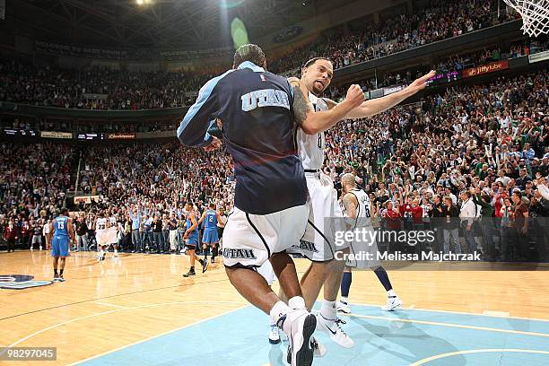 Deron Williams of the Utah Jazz celebrates with teammate Ronnie Price after defeating the Oklahoma City Thunder 140-139 at EnergySolutions Arena on...