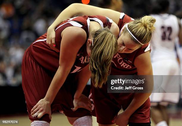 Kayla Pedersen of the Stanford Cardinal is consoled by teammate JJ Hones following their teams defeat to the Connecticut Huskies during the NCAA...