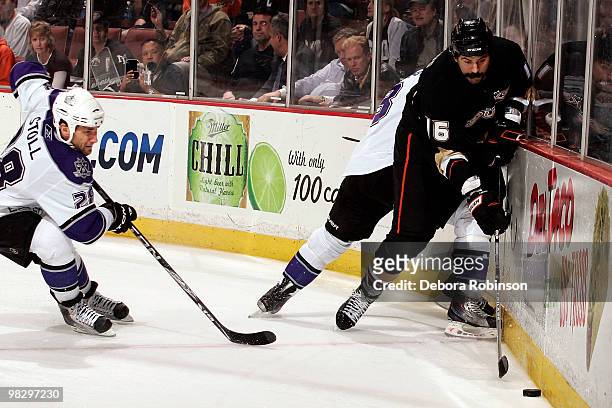 Jarret Stoll of the Los Angeles Kings defends as George Parros of the Anaheim Ducks handles the puck alongside the boards during the game on April 6,...